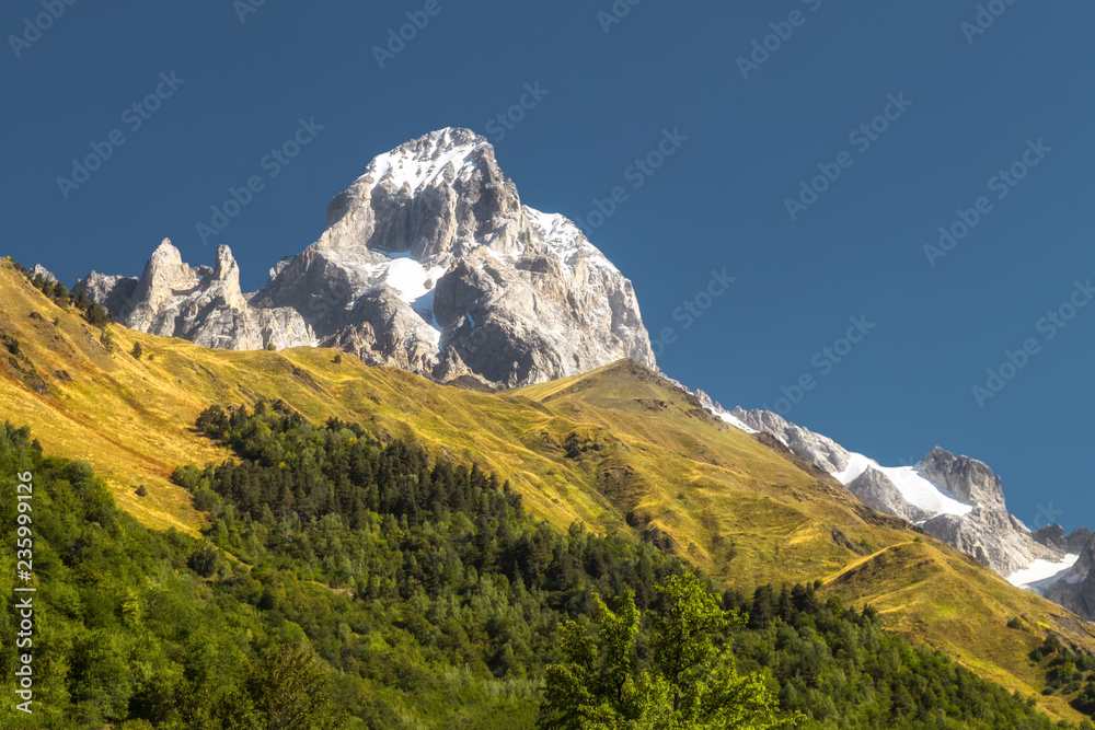 The peak of mountain Ushba with clean blue sky