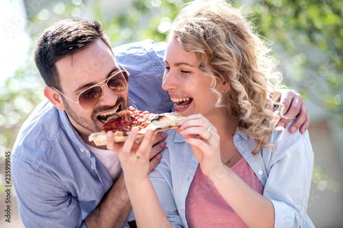 Happy couple sharing pizza