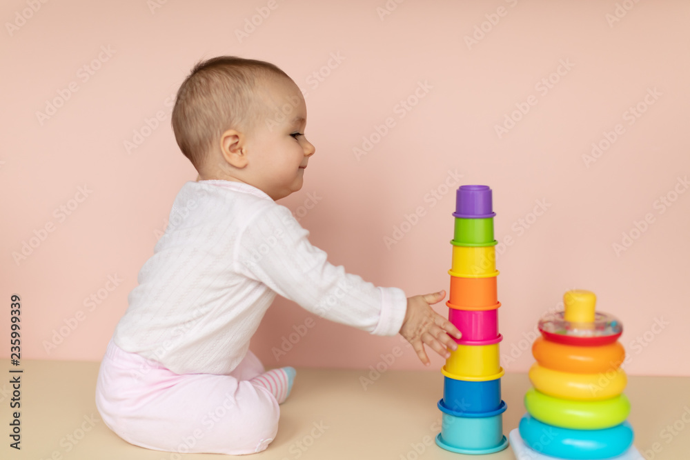 Cute baby girl developing motoric skills and learning colors Cute baby girl developing motoric skills and learning colors