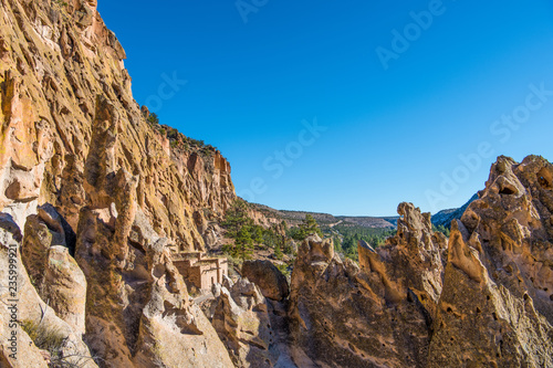 Colorful jagged rock formations, high cliffs, and ancient adobe ruins in Bandelier National Monument near Santa Fe, New Mexico photo
