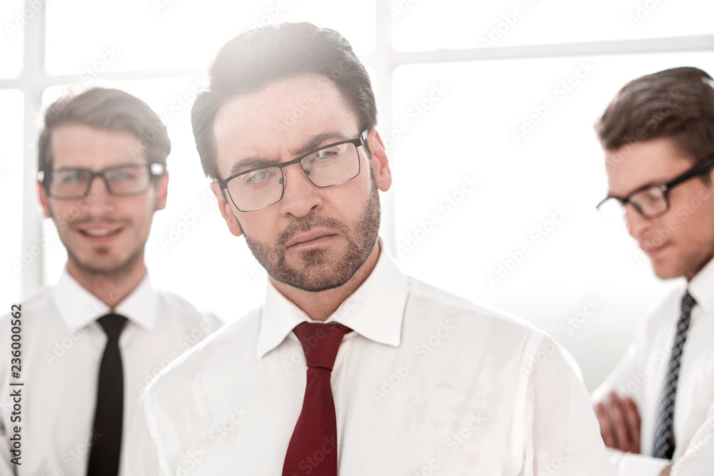 close up.confident businessman on background of colleagues close up.confident businessman on background of colleagues