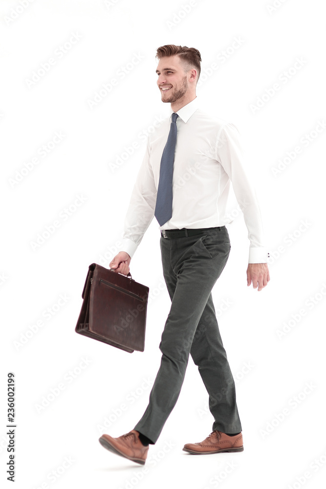 side view.smiling businessman confidently steps forward side view.smiling businessman confidently steps forward