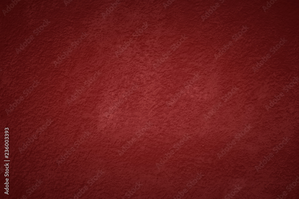 Fototapeta premium Red tone wall texture abstract background. Christmas background with copy space and darker vignette.
