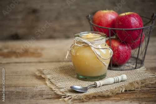 Old wooden table with fresh made Applesauce (selective focus; close-up shot)  photo