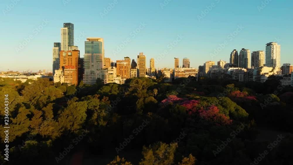 Wide Aerial drone view of Palermo Neighborhood in Buenos Aires during sunset with city park and skyscrapers buildings. Warm orange colors. Wide Aerial drone view of Palermo Neighborhood in Buenos Aires during sunset with city park and skyscrapers buildings. Warm orange colors.