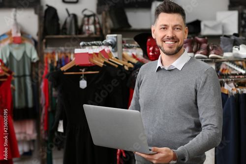 Business owner with laptop ...