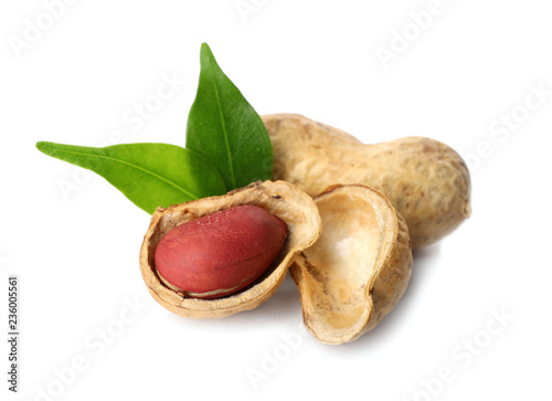 Raw peanuts and leaves on white background. Healthy snack