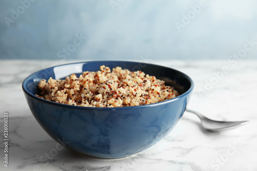 Cooked delicious quinoa in bowl on table