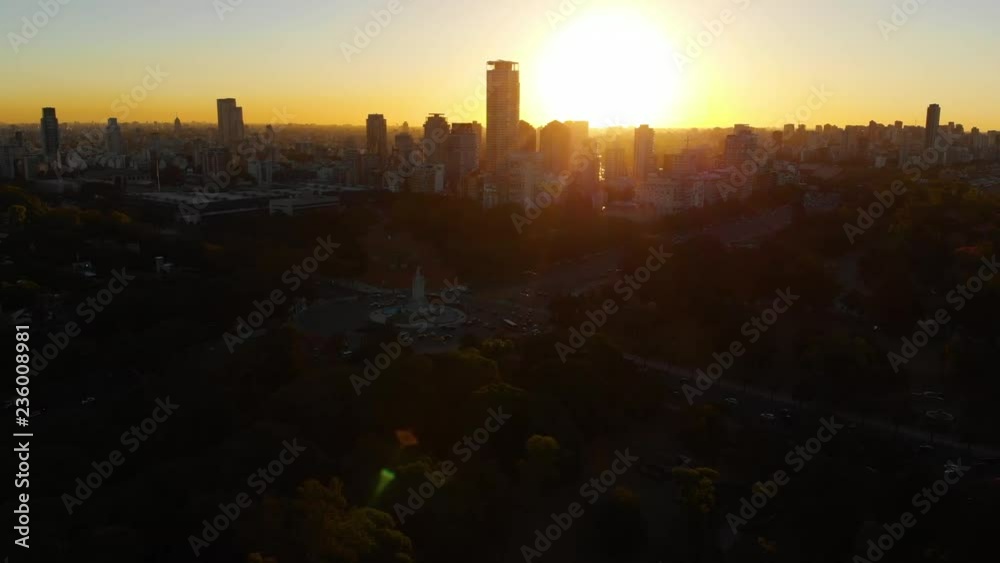 Wide Aerial drone view of Palermo Neighborhood in Buenos Aires during sunset. Silhouette and shape of buildings and skyscrapers in the background with orange sun and dark contrast Wide Aerial drone view of Palermo Neighborhood in Buenos Aires during sunset. Silhouette and shape of buildings and skyscrapers in the background with orange sun and dark contrast