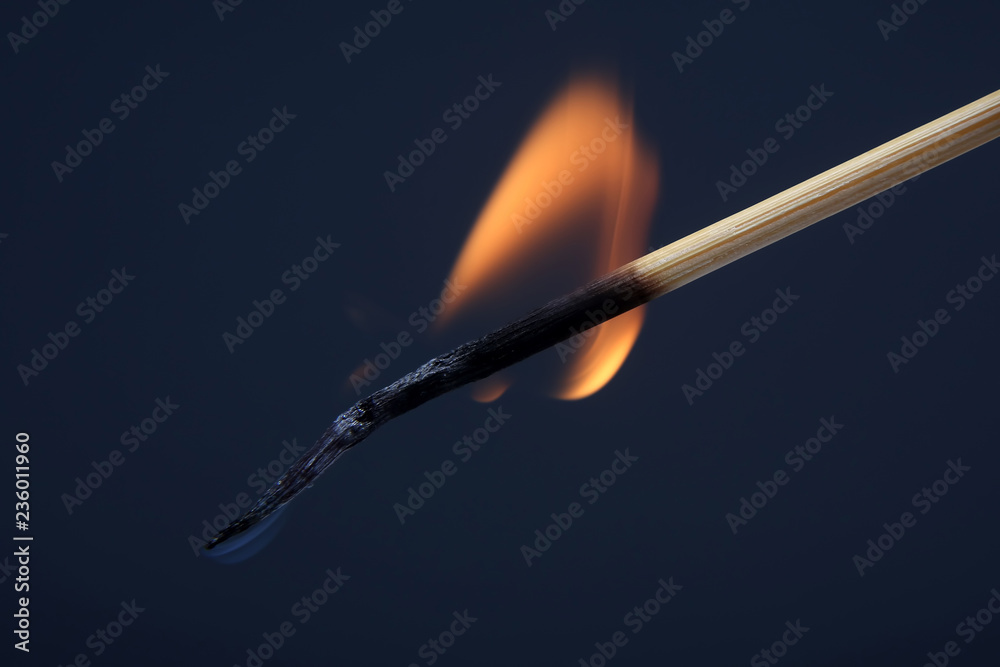 burning and Smoking wooden match on dark background