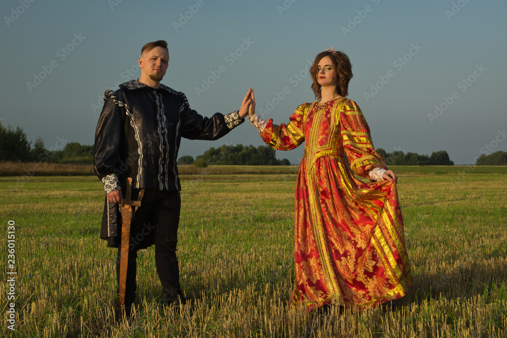 Knight with sword and girl in renaissance dress