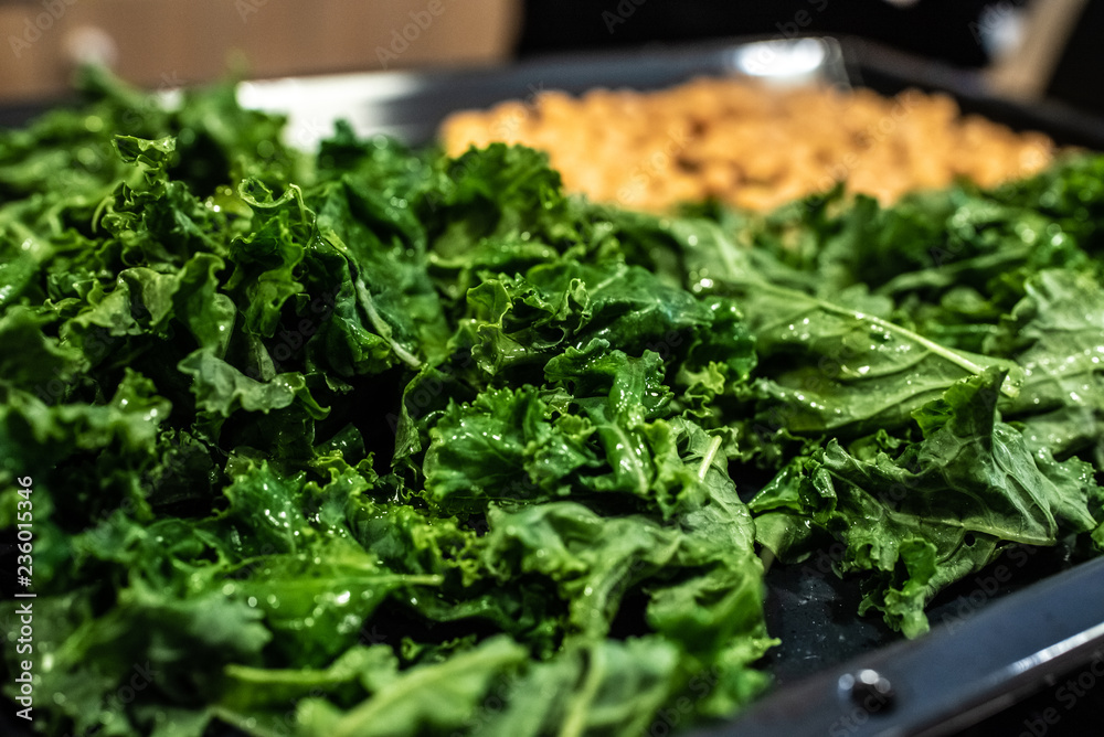 Chef preparing a dish of kale and chickpeas. Chef preparing a dish of kale and chickpeas.