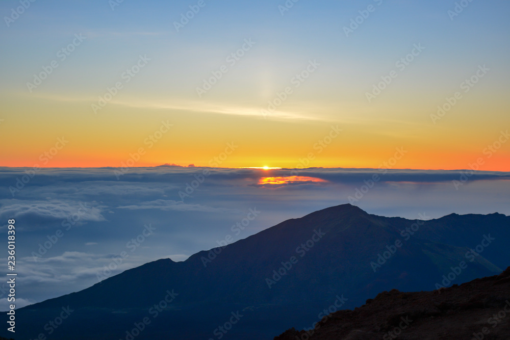 Sunrise at the summit of Haleakala volcano on the island of Maui, Hawaii.
