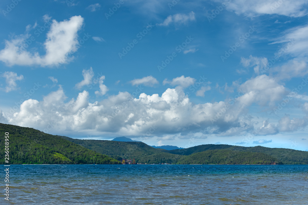 tropic beach and see , with blue sky and whit clouds