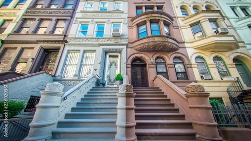 Looking up the steps of large multicolored stoops in the Upper West Side neighborhood of Manhattan in New York City of The United States of America.