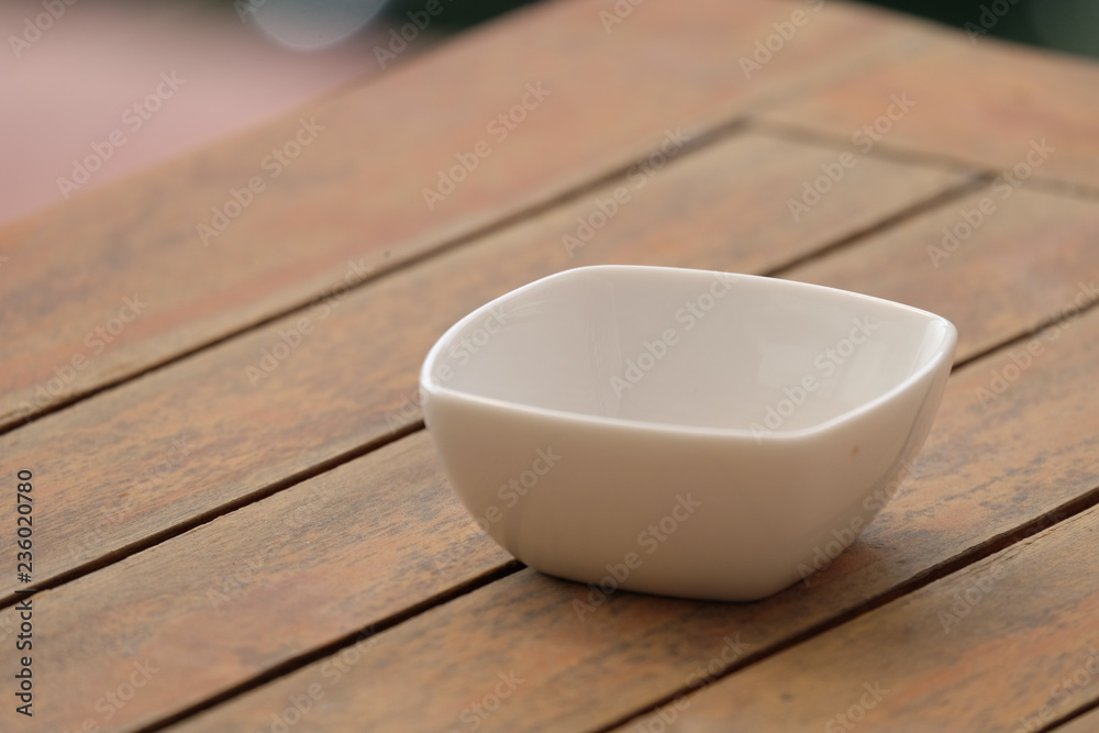 white bowl on wood table.