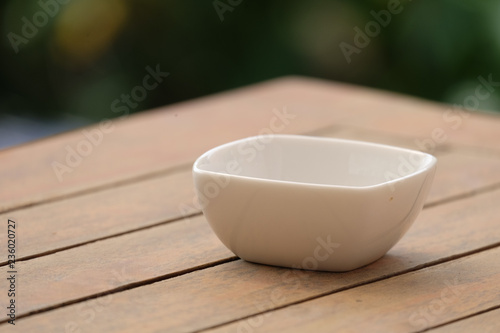 Fototapeta Naklejka Na Ścianę i Meble -  white bowl on wood table.