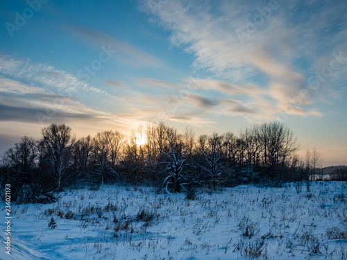 winter sunset over the field and forest with clouds, Novosibirsk, Russia