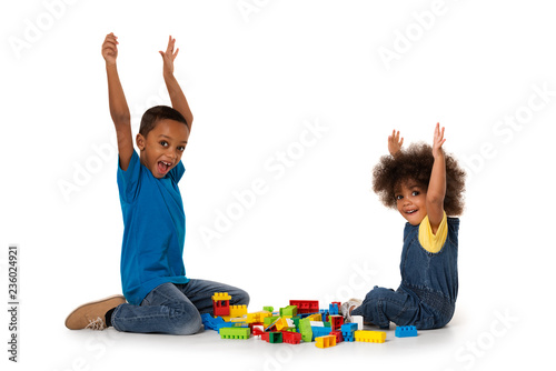 Wallpaper Mural Little african excited kids playing with lots of colorful plastic blocks indoor. Isolated Torontodigital.ca