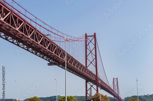Closeup of the bridge '25 of April' against blue sky on a clear day