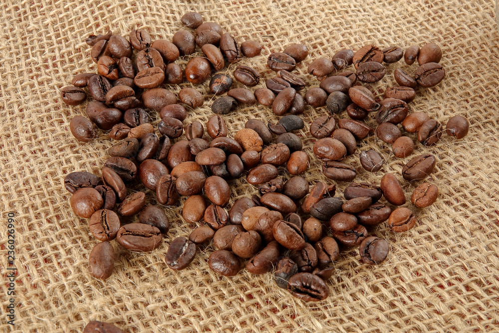 Fototapeta premium Coffee beans on a rug background