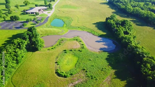 A view of the 2 different color ponds in a field photo