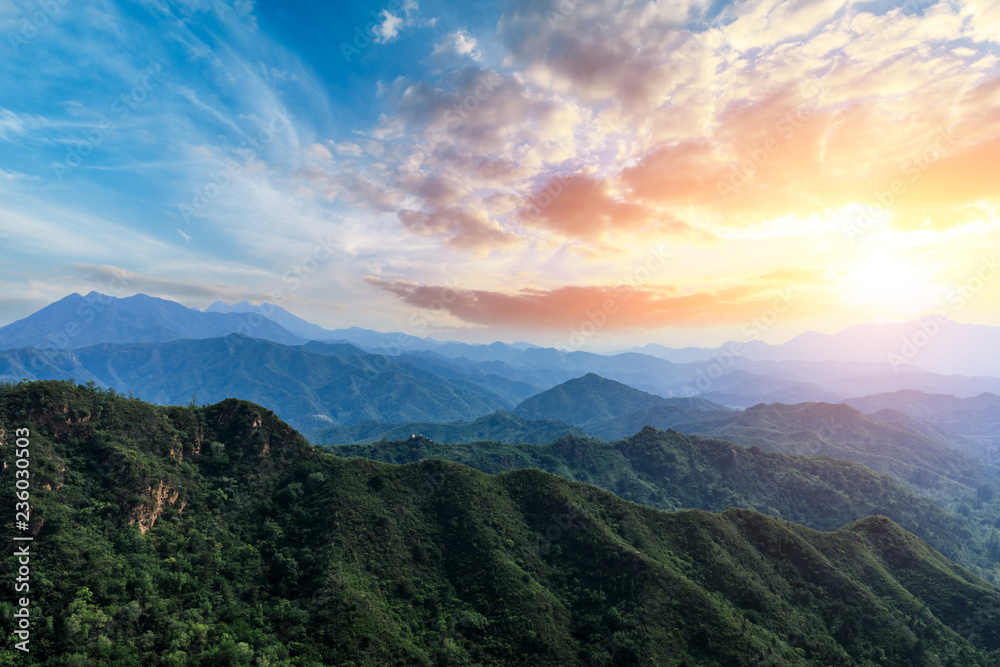 Naklejka premium Green mountain and colorful cloud at sunset