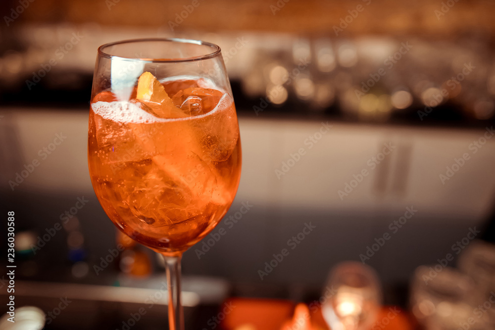 glasses of cocktails on the bar. bartender pours a glass of sparkling wine with Aperol.