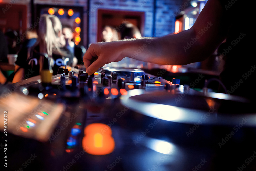 Dj playing disco house progressive electro music at the concert. DJ hands on equipment Dj playing disco house progressive electro music at the concert. DJ hands on equipment