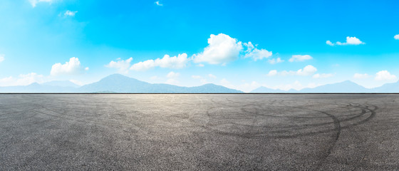 Asphalt road pavement and green mountain