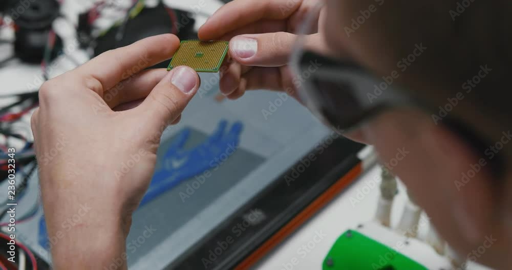 Close up of male hands holding computer chip Close up of male hands holding computer chip