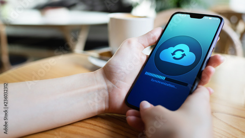 Mobile phone cloud synchronisation process on device screen. Technology concept. photo