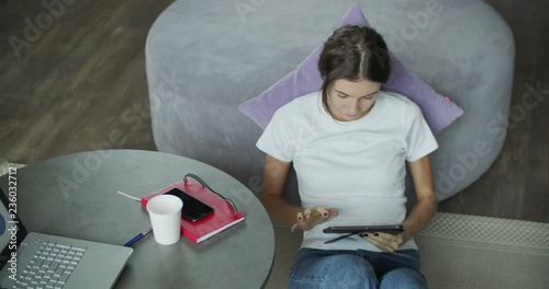 Young woman using digital tablet computer in home photo