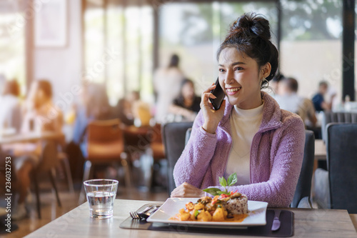 woman talking on mobile phone in restaurant