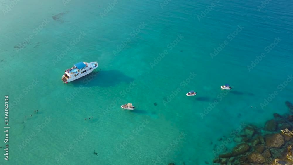 Cruise ship and boats in blue lagoon of Mediterranean sea aerial shot Cruise ship and boats in blue lagoon of Mediterranean sea aerial shot