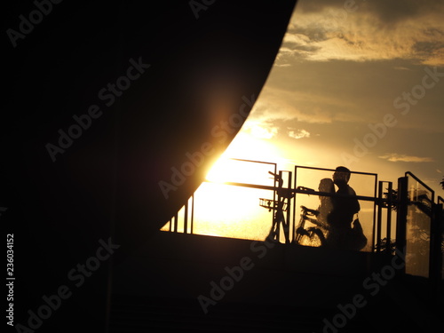 People's Sunset Silhouette at the Helix Bridge with bicycles