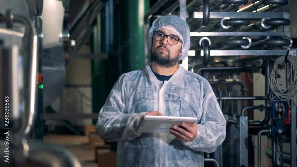 Male employee is working in a facility of a distillery unit Male employee is working in a facility of a distillery unit