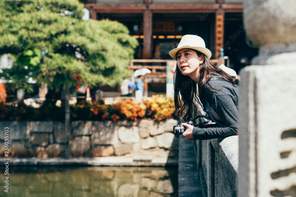 tourist with straw hat standing above the pond tourist with straw hat standing above the pond