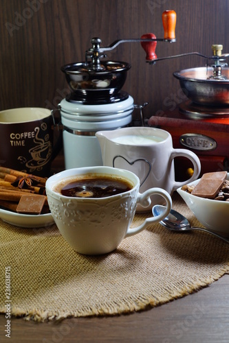 Aromatic hot coffee in a cup and in beans  spices and chocolate  
