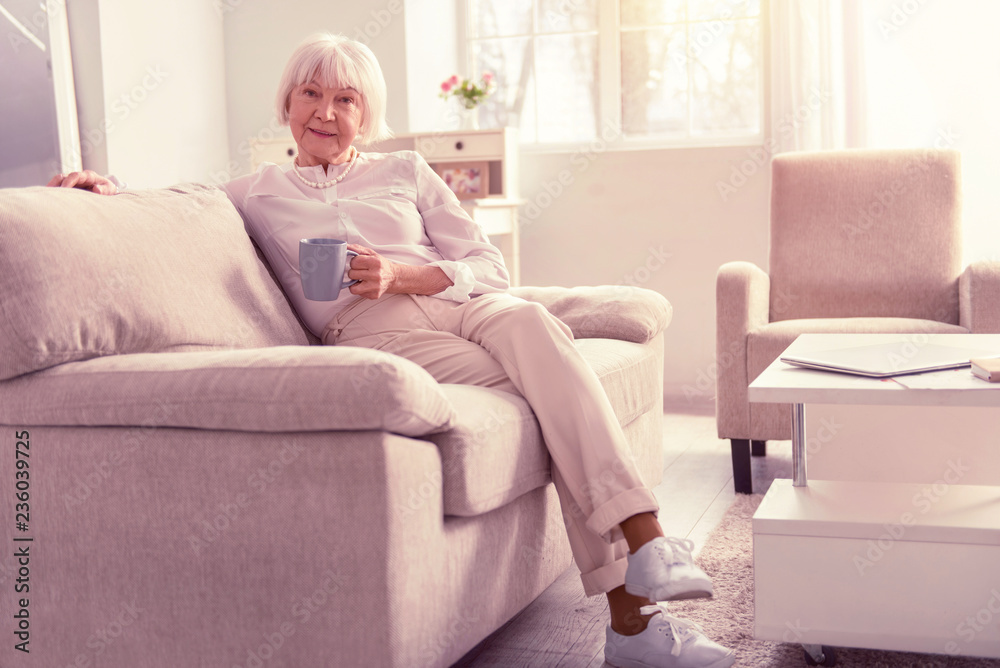 Nice positive pensioner wearing light fashionable clothes Nice positive pensioner wearing light fashionable clothes