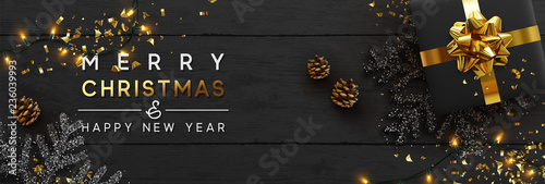 Christmas banner. Background Xmas design of sparkling lights garland, with realistic gifts box, black snowflake and glitter gold confetti. Horizontal christmas poster, greeting cards, headers, website