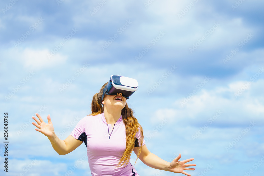 Fototapeta premium Woman wearing VR outside