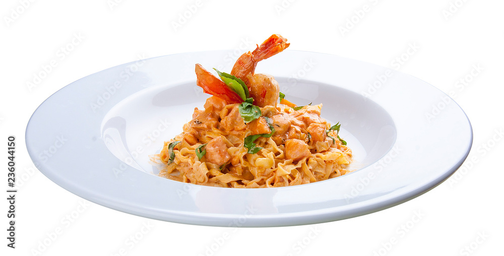 Pasta with salmon and shrimp. On a white background. Pasta with salmon and shrimp. On a white background.