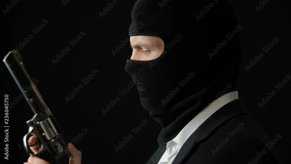 Political criminal in balaclava holding gun, preparing for attack, corruption Political criminal in balaclava holding gun, preparing for attack, corruption