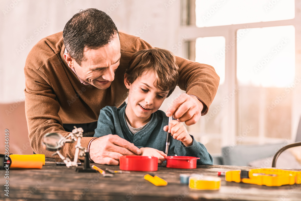 Caring dad looking after his son's route to success. Caring dad looking after his son's route to success.