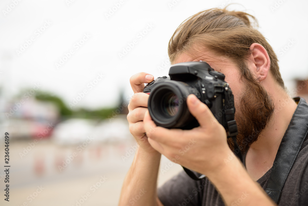 Young bearded tourist man having vacation in Ayutthaya, Thailand Young bearded tourist man having vacation in Ayutthaya, Thailand