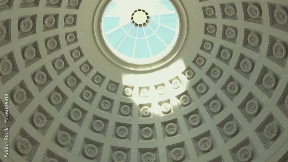 pan shot of a round dome, sun shines through a small window on the ceiling, and illuminates an old architecture, in the sun, at Grabkapelle Stuttgart, Baden W√ºrttenberg, in Germany