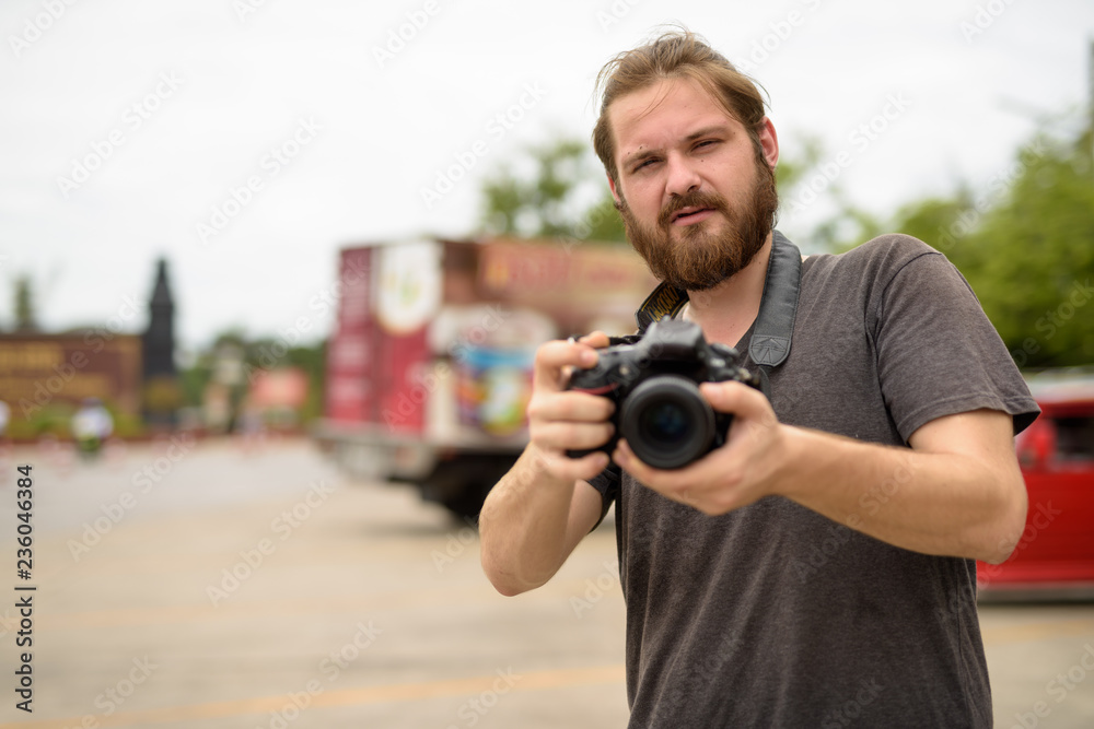 Young bearded tourist man having vacation in Ayutthaya, Thailand Young bearded tourist man having vacation in Ayutthaya, Thailand