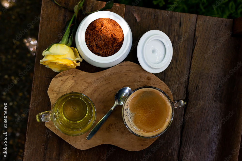 Coffee and tea are on the wooden table in green garden
Coffee and tea are on the wooden table in green garden