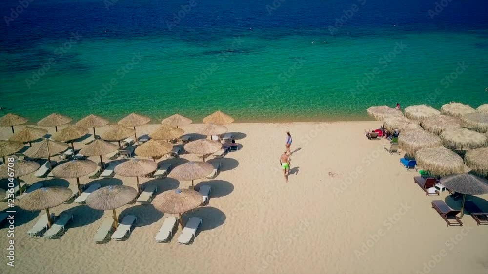 Beautiful beach with family top aerial view drone shot, Sithonia, Greece Beautiful beach with family top aerial view drone shot, Sithonia, Greece